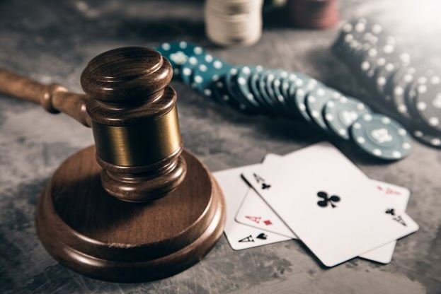 A gavel, playing cards, and casino chips